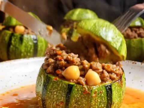 Tender stuffed round zucchini with beef and chickpea filling, cut open to show the savory interior