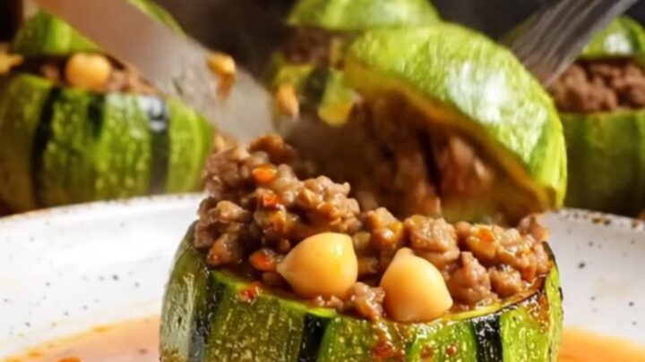 Tender stuffed round zucchini with beef and chickpea filling, cut open to show the savory interior