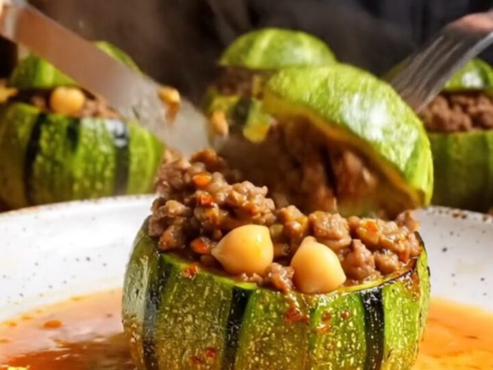 Tender stuffed round zucchini with beef and chickpea filling, cut open to show the savory interior