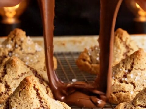 Giant thick cookie broken open showing gooey molten chocolate