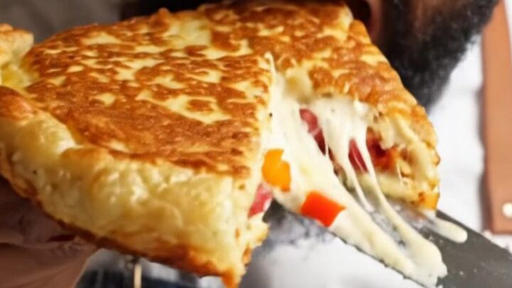 Sliced XXL savory pancake showing melted cheese and sucuk pieces