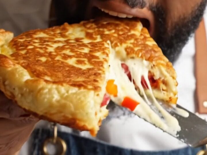 Sliced XXL savory pancake showing melted cheese and sucuk pieces