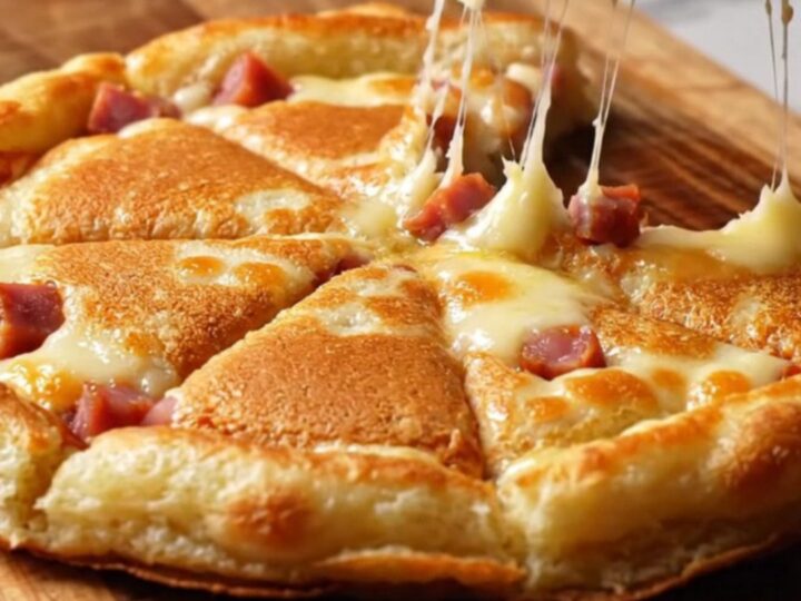 Golden sucuk and kashar pancake wedges on a wooden board, with melted cheese and crispy edges