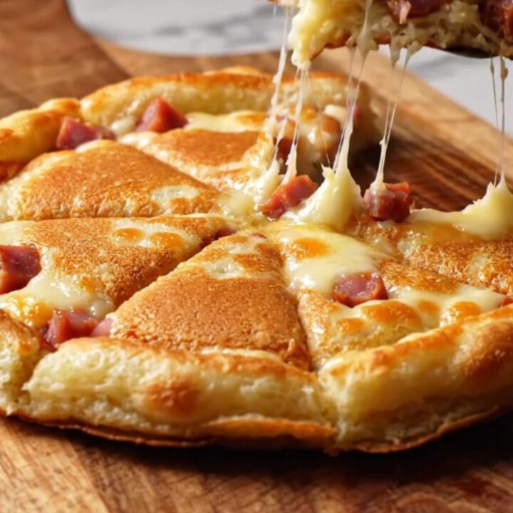 Golden sucuk and kashar pancake wedges on a wooden board, with melted cheese and crispy edges