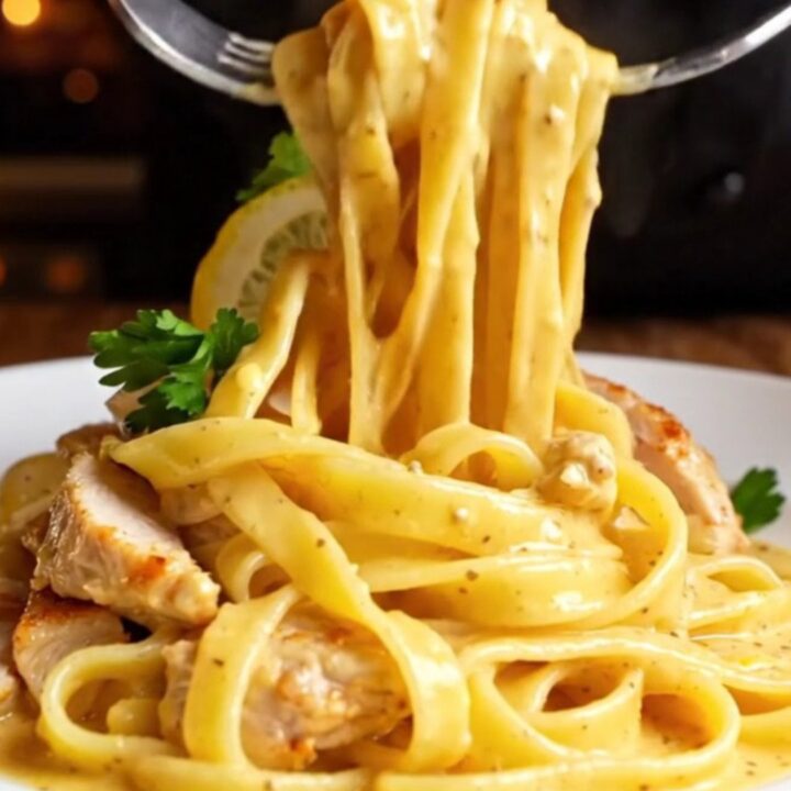 Golden seared chicken and fettuccine tossed in a creamy lemon garlic sauce, garnished with parsley and lemon wheels.