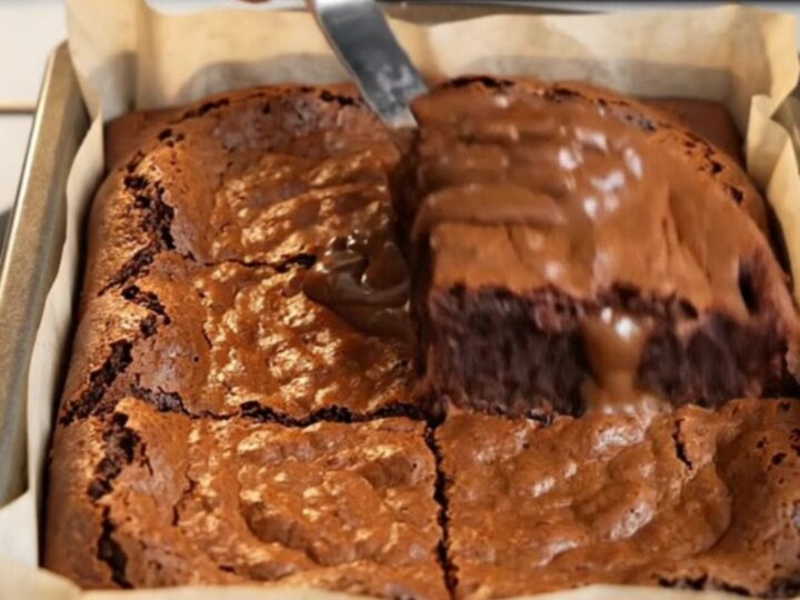 Crinkle top fudgy brownies with a shiny cracked crust and dense chocolate interior