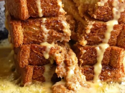 Cinnamon Roll French Toast stack with cream cheese glaze dripping down the sides