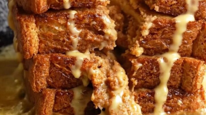 Cinnamon Roll French Toast stack with cream cheese glaze dripping down the sides