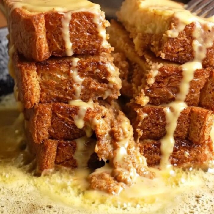 Cinnamon Roll French Toast stack with cream cheese glaze dripping down the sides
