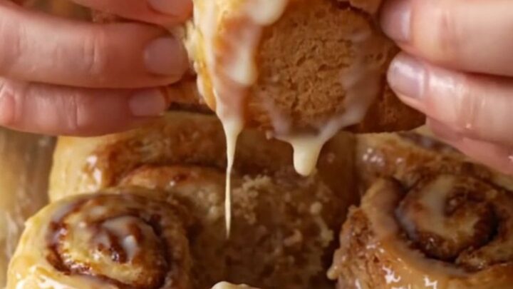 Bakery-style cinnamon rolls with cream cheese frosting, pulling apart