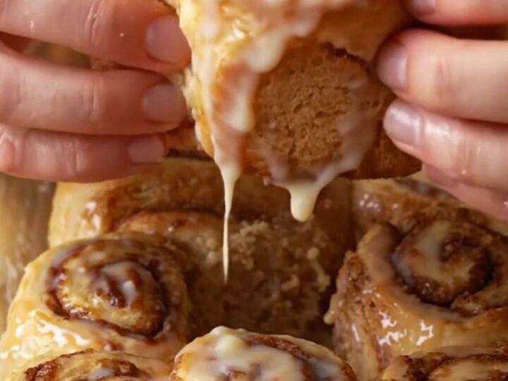 Bakery-style cinnamon rolls with cream cheese frosting, pulling apart