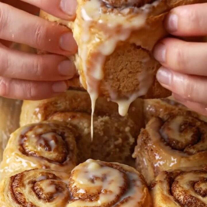 Bakery-style cinnamon rolls with cream cheese frosting, pulling apart