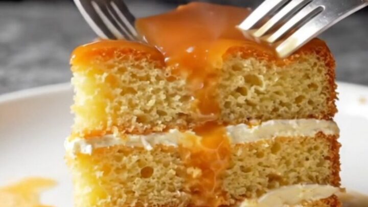 Golden caramel trileçe with creamy top and glossy amber caramel, slice lifted showing soaked layers