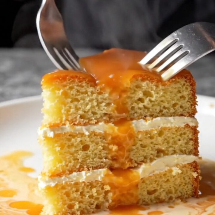 Golden caramel trileçe with creamy top and glossy amber caramel, slice lifted showing soaked layers