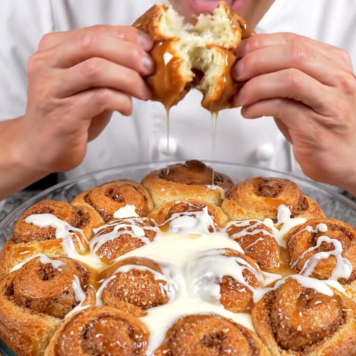 Pull-apart cinnamon monkey bread rolls with cream cheese glaze in a baking dish