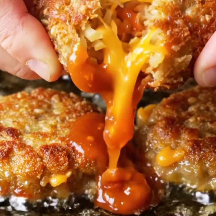 Crispy potato veggie patties stacked on a plate with a bowl of spicy Kewpie dip