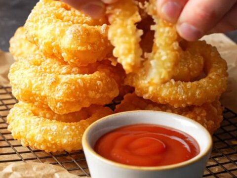 Golden crispy smiley face potato fries with ketchup on a plate