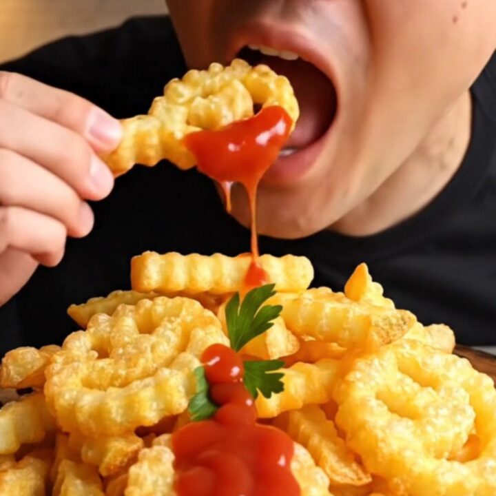 Golden crispy smiley potato fries with ketchup on a plate
