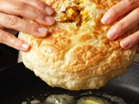 Golden potato bazlama flatbread torn open, showing creamy filling and steam