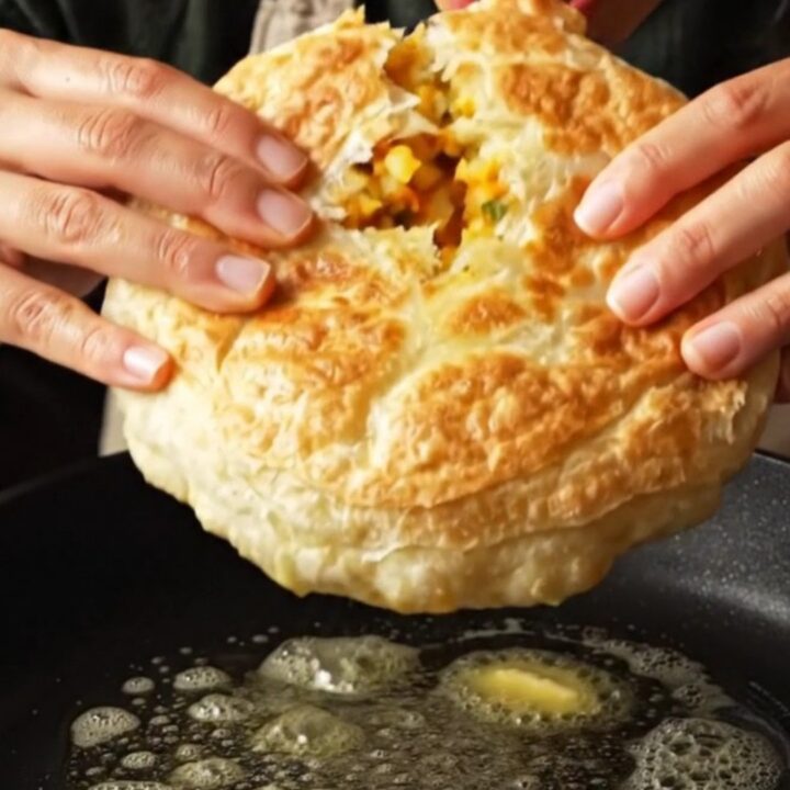 Golden potato bazlama flatbread torn open, showing creamy filling and steam