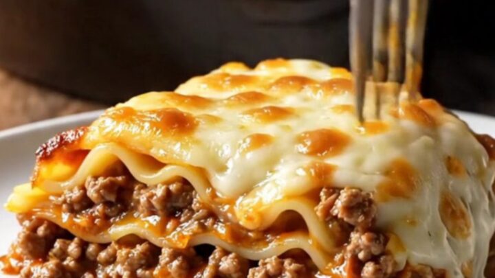 One-pan skillet lasagna with ground beef Bolognese, melted mozzarella, and parsley in a cast-iron skillet.