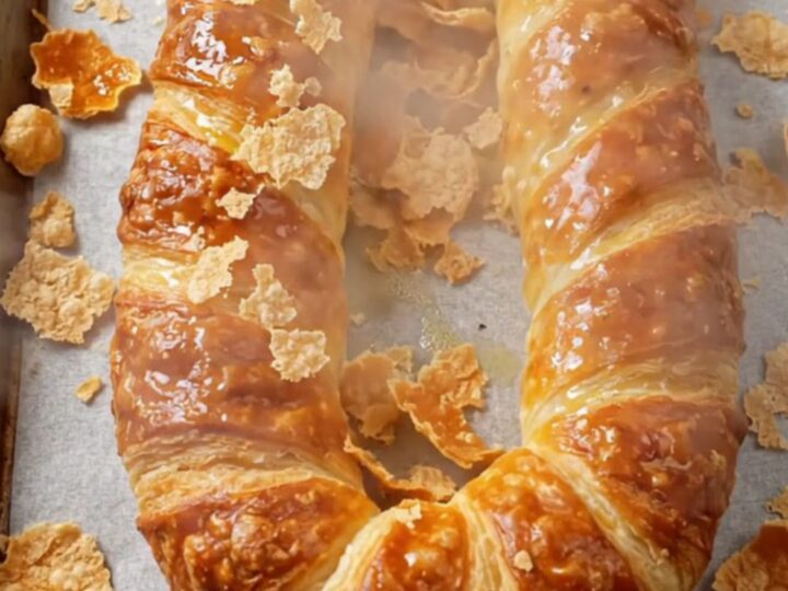 Golden horseshoe börek on parchment paper with a crisp, blistered crust