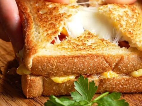 Golden crispy toast pocket cut open showing melted cheese and sucuk
