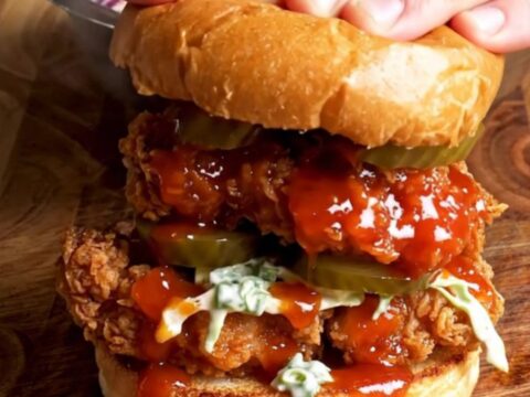 Nashville hot chicken sandwich with glazed chicken, ranch slaw, and pickles on a brioche bun