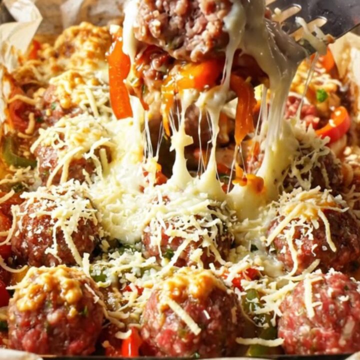 Turkish baked meatballs and vegetables in a glass dish with melted cheese