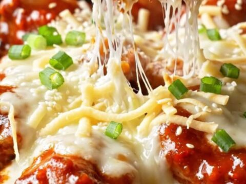 Skillet of Korean cheesy fire chicken with bubbling mozzarella and charred edges