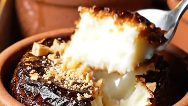 Cracked caramelized top of Turkish rice pudding in a clay bowl