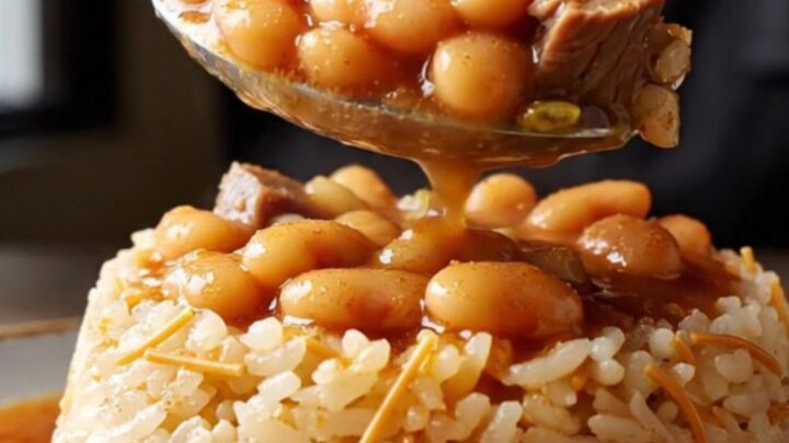 A clay pot of slow-braised white beans with pastırma, ready to be served over butter rice