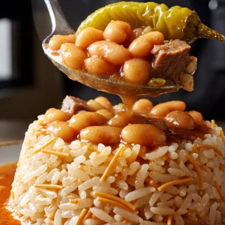 A clay pot of slow-braised white beans with pastırma, ready to be served over butter rice