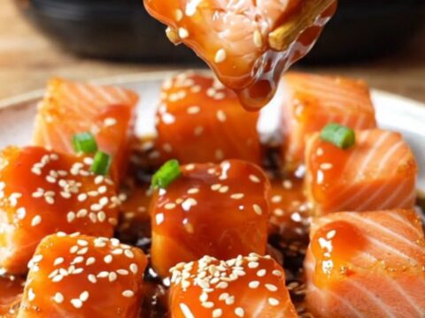 Crispy air-fried sweet chili salmon bites glazed and garnished with sesame seeds and scallions