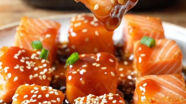 Crispy air-fried sweet chili salmon bites glazed and garnished with sesame seeds and scallions