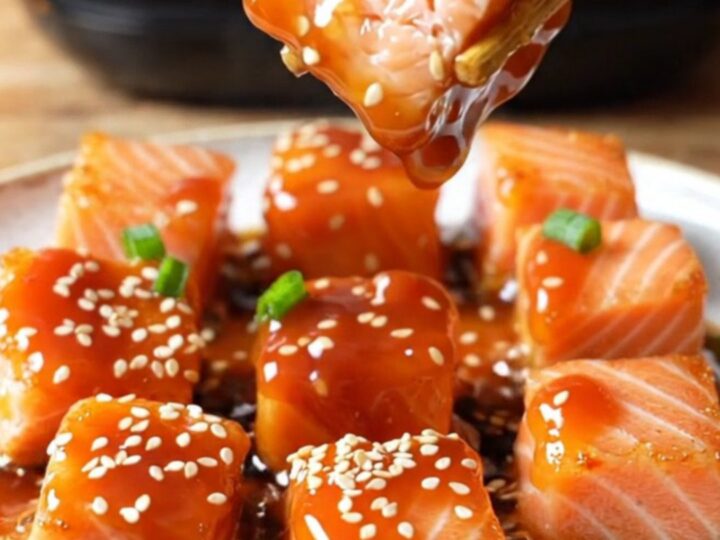 Crispy air-fried sweet chili salmon bites glazed and garnished with sesame seeds and scallions