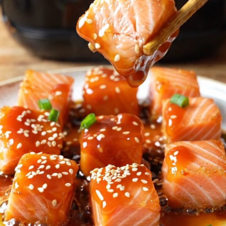 Crispy air-fried sweet chili salmon bites glazed and garnished with sesame seeds and scallions