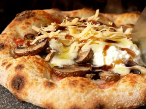 Golden crispy flatbread topped with bubbling fontina, sautéed wild mushrooms, and ricotta dollops