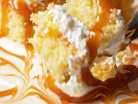 A square slice of Turkish Trileçe with caramel glaze and whipped cream layers