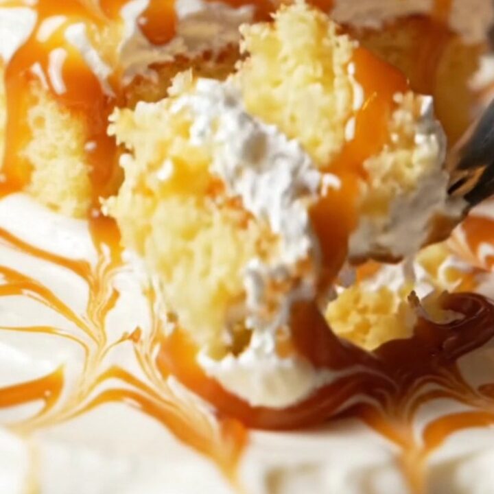A square slice of Turkish Trileçe with caramel glaze and whipped cream layers