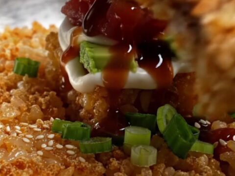 Golden crispy rice squares topped with spicy tuna tartare, avocado, and sweet soy drizzle
