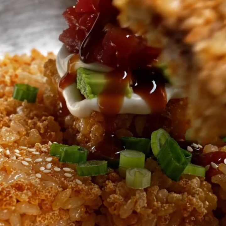 Golden crispy rice squares topped with spicy tuna tartare, avocado, and sweet soy drizzle