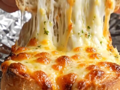 Pull-apart stuffed baguette with molten cheese stretch