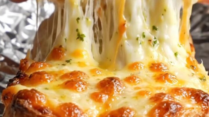 Pull-apart stuffed baguette with molten cheese stretch