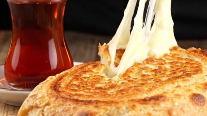 Crispy Turkish sucuklu kaşarlı tost cut diagonally, showing melted cheese and seared sausage