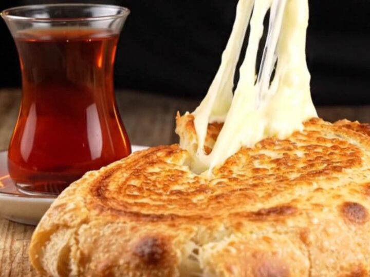 Crispy Turkish sucuklu kaşarlı tost cut diagonally, showing melted cheese and seared sausage