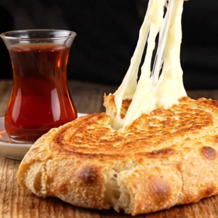 Crispy Turkish sucuklu kaşarlı tost cut diagonally, showing melted cheese and seared sausage