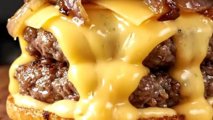 Double smash burger with caramelized onions and melted Gruyère on a brioche bun