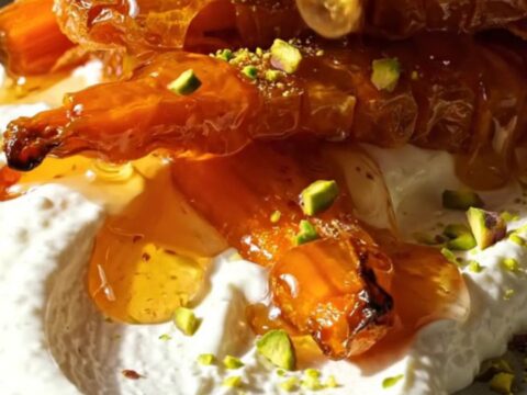 Crispy accordion carrots with whipped feta and hot honey on a ceramic platter