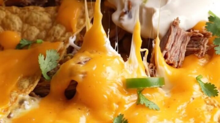 Loaded skillet nachos with smoked brisket, molten queso, and toppings
